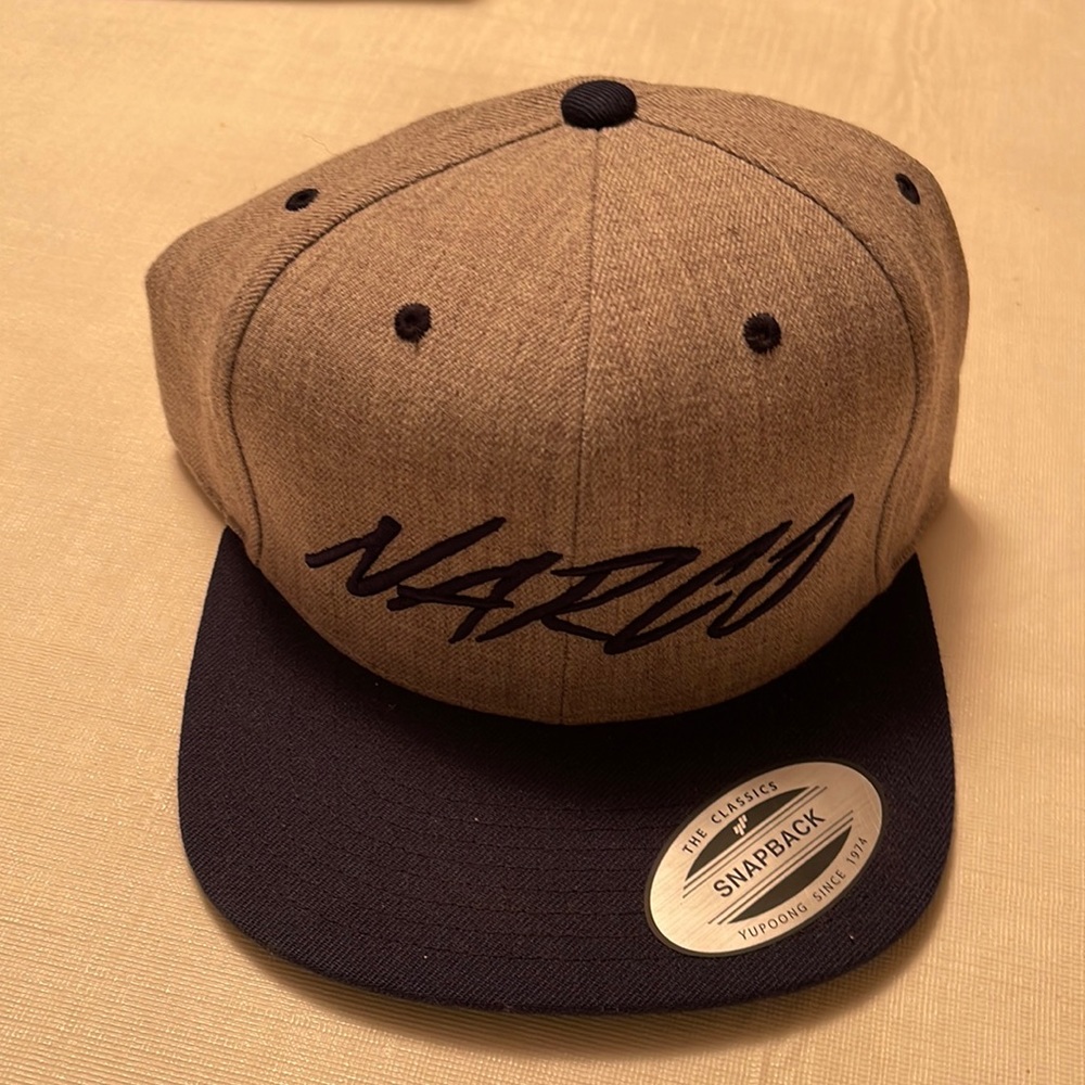 A “narco” snap back hat